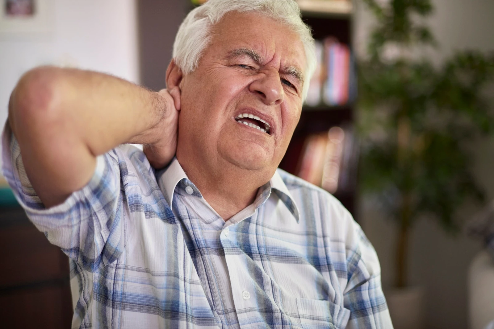 A man holding his neck in pain after a crash